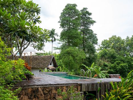 Swimming pool in beautiful park at Northern resort of Thailand.