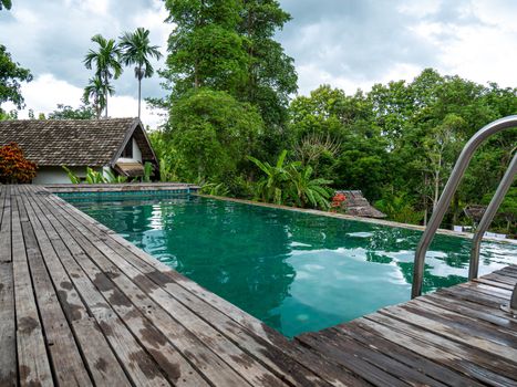 Swimming pool in beautiful park at Northern resort of Thailand.