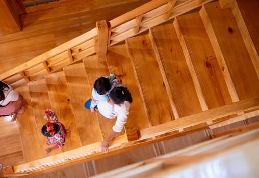 Asian tourist walking on wooden stairs to look in Hinoki land; Japanese building style for travel in Chaiprakarn district Chiang Mai,Thailand.