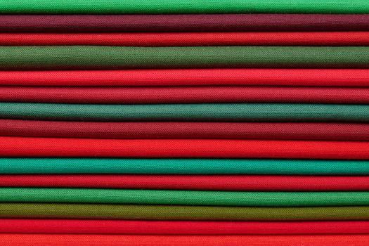 Stack of red and green fabrics as a vibrant background image
