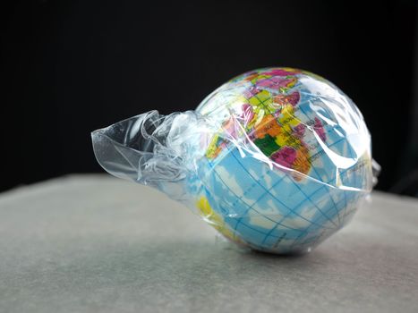 The earth in plastic bag, Global warming due to pollution by plastic debris. The concept of Earth Day.