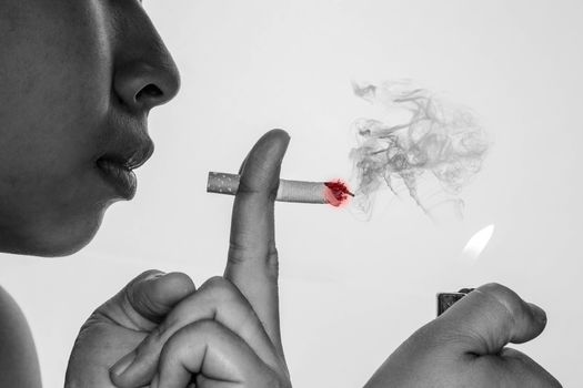 World No Tobacco Day; Asian young woman is smoking isolated on grey background with space for text.