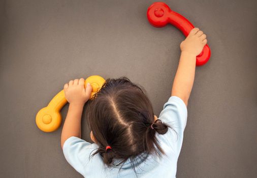 Asian little child girl climbing to slide at playground.