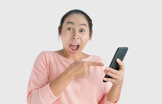 Asian woman angry and yelled what she see in the smartphone and pointing it, Isolated on white background.