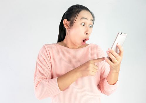 Surprised face of Asian woman shocked what she see in the smartphone, Isolated on white background.