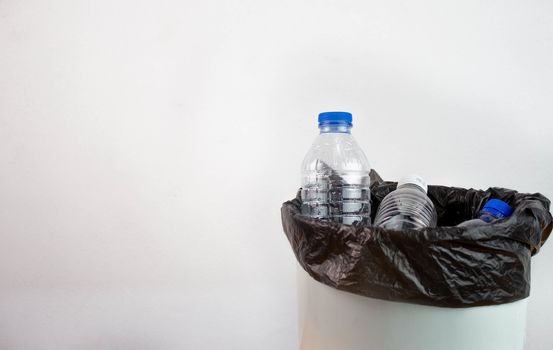 Empty plastic water bottle in recycling bin waiting to be taken to recycle. Concept save the earth.