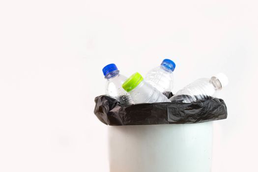 Empty plastic water bottle in recycling bin waiting to be taken to recycle. Concept save the earth.