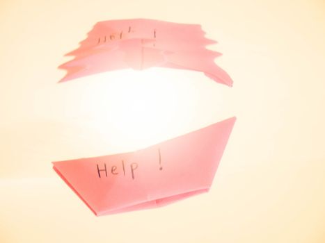 Close-up of sinking folded paper boat into the water. Mental state and Emotional concept.