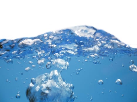 Air bubbles rising up to surface in blue pure water. Abstract background.