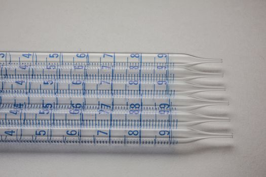 Glass pipettes in the laboratory with scale