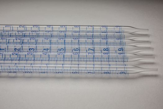 Glass pipettes in the laboratory with scale