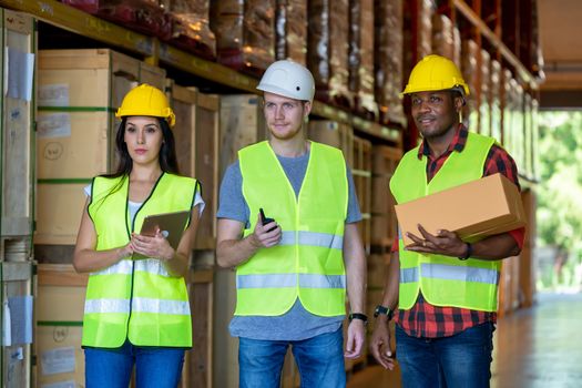 Warehouse manager and foreman working together in a large warehouse