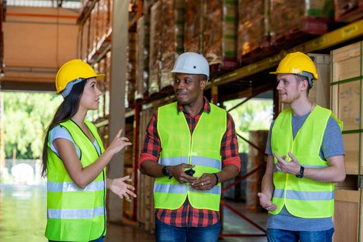 Warehouse manager and foreman working together in a large warehouse