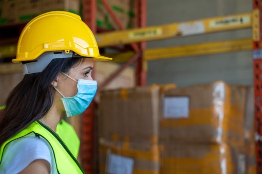 Workers wearing protective mask to Protect Against Covid-19 in warehouse.