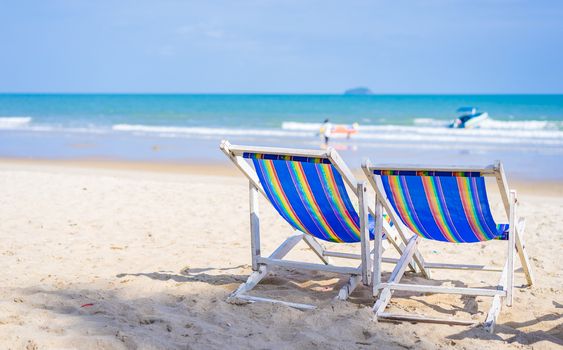 Beach chairs on the white sand beach in summer