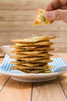 Stack of salty vegetable flavored crackers.