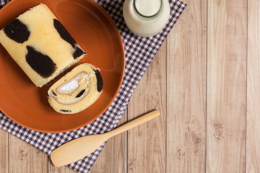 Cake roll with cow-skin pattern inserted with fresh milk cream.