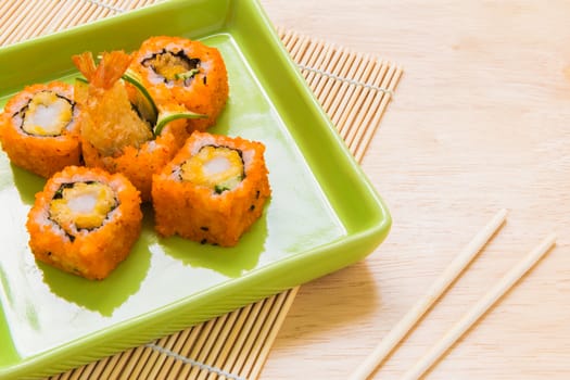 Traditional Japanese food, sushi roll, on wooden background