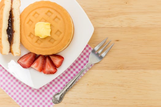 Background of waffle and tea on wooden table for tea break or coffee break.