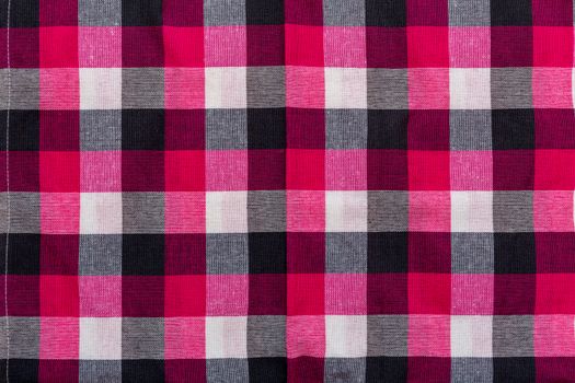 Tablecloth with square pattern with red, white, and black.