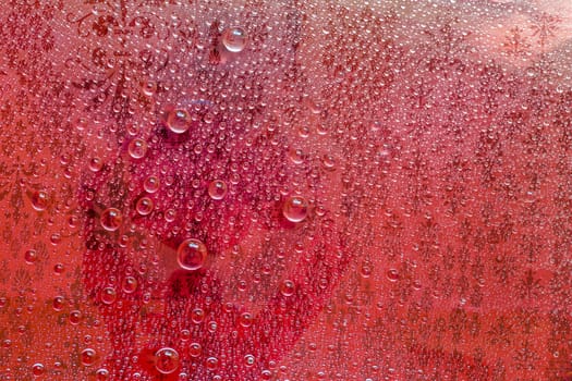 Water drop, droplet, raindrop of red background