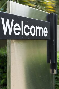 Welcome sign greeting visitor in front of the gate.