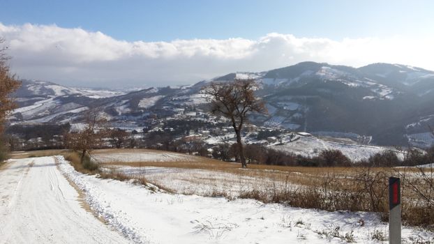 The countryside of Umbria near to Gubbio under the snow during the Winter - Beautiful landscape covered by snow in a sunny day