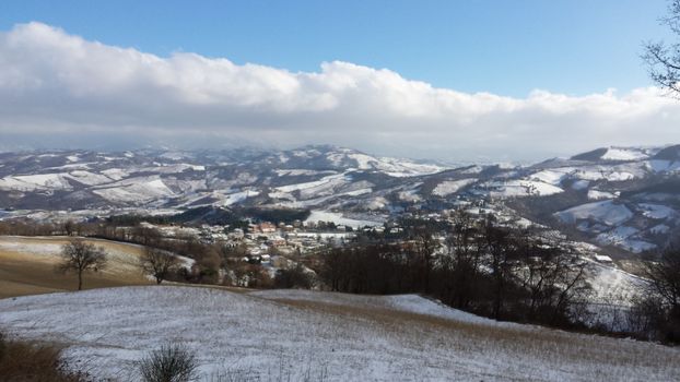 The countryside of Umbria near to Gubbio under the snow during the Winter - Beautiful landscape covered by snow in a sunny day