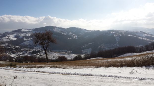 The countryside of Umbria near to Gubbio under the snow during the Winter - Beautiful landscape covered by snow in a sunny day