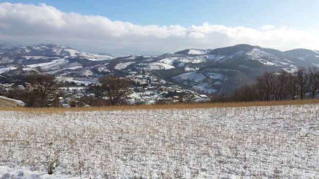 The countryside of Umbria near to Gubbio under the snow during the Winter - Beautiful landscape covered by snow in a sunny day