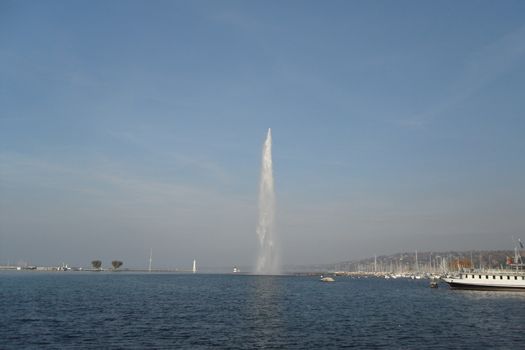 Geneva, Switzerland - Classical view of the famous water fountain of Geneva lake, the symbol of Geneva. Beautiful romantic scenery of Swiss city.