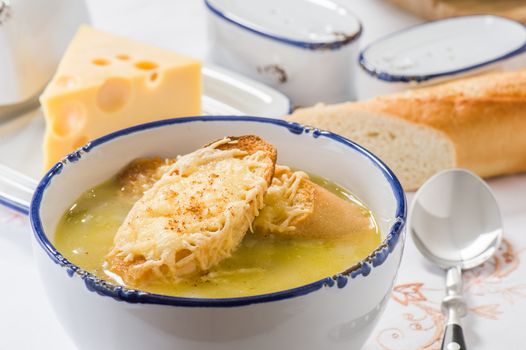 Onion soup with toast in a white bowl