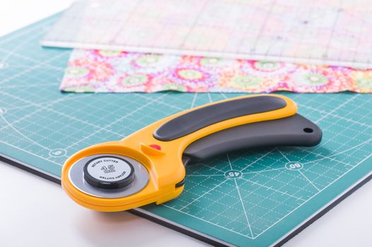 Rotary cutter on plan front on green mat