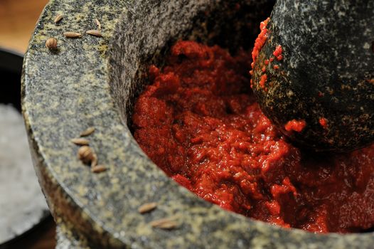 Harissa chili paste in a mortar with pestle
