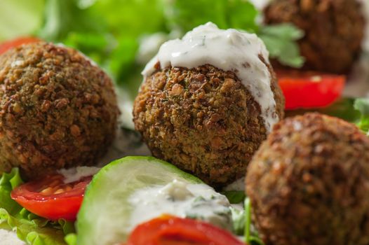 Falafel on salad leaves with tomatoes, cucumber and pepper