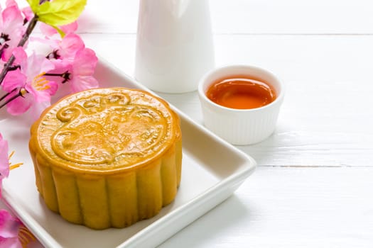 Traditional Chinese mooncake eaten with hot tea for relaxing time.