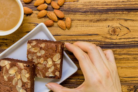Chocolate almond brownie for relaxing coffee break.