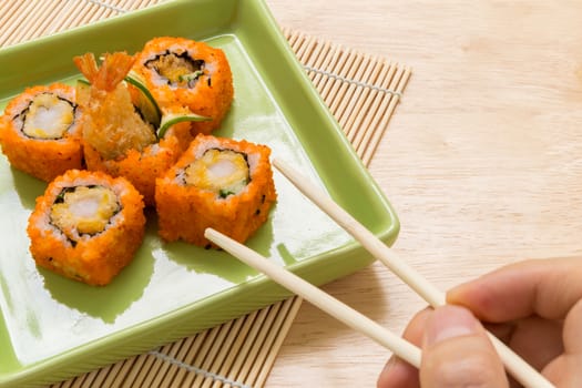 Traditional Japanese food, sushi roll, on wooden background