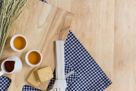 Wood Texture Background Decorated by Cutting Plate, Cups of Tea, and Biscuits
