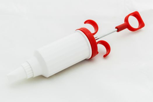Icing syringe isolated on white background.