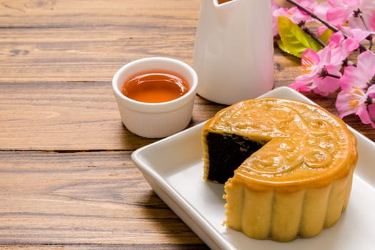 Traditional Chinese mooncake eaten with hot tea for relaxing time.