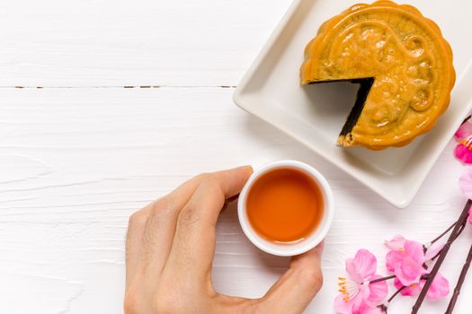 Traditional Chinese mooncake eaten with hot tea for relaxing time.