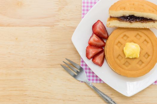 Background of waffle and tea on wooden table for tea break or coffee break.