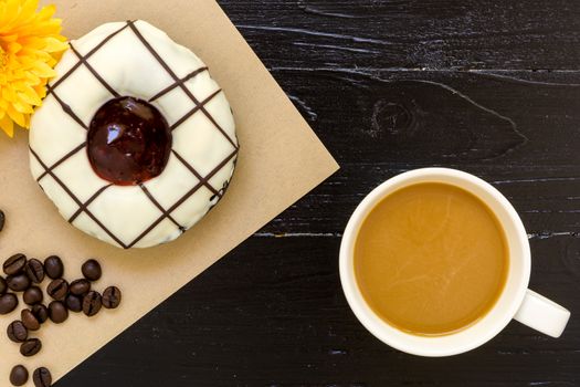 Fresh donut or doughnut with cup of hot coffee for relaxing moment.