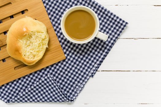 Coconut bun with cup of coffee for breakfast background.