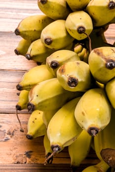Bunch of ripe banana on wooden background.