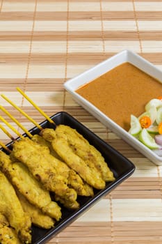 Thai grilled curry pork with peanut sauce and salad.
