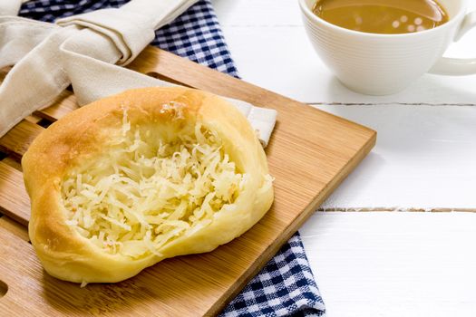 Coconut bun with cup of coffee for breakfast background.