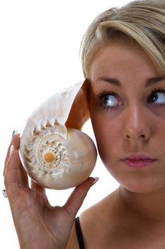 Girl listening to a conch shell