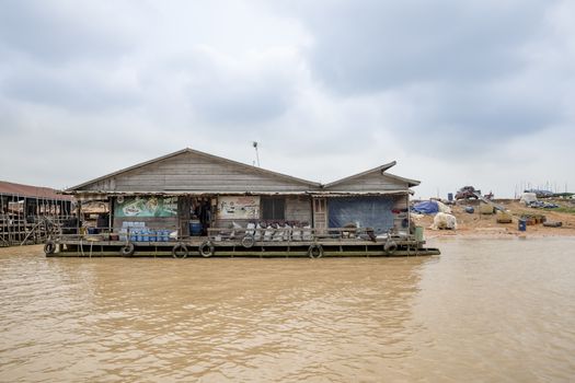 Building (home or grocery?) floating on Siem Reap river going to Tonle Sap lake, a famous tourist destination of Siem Reap Province, Cambodia